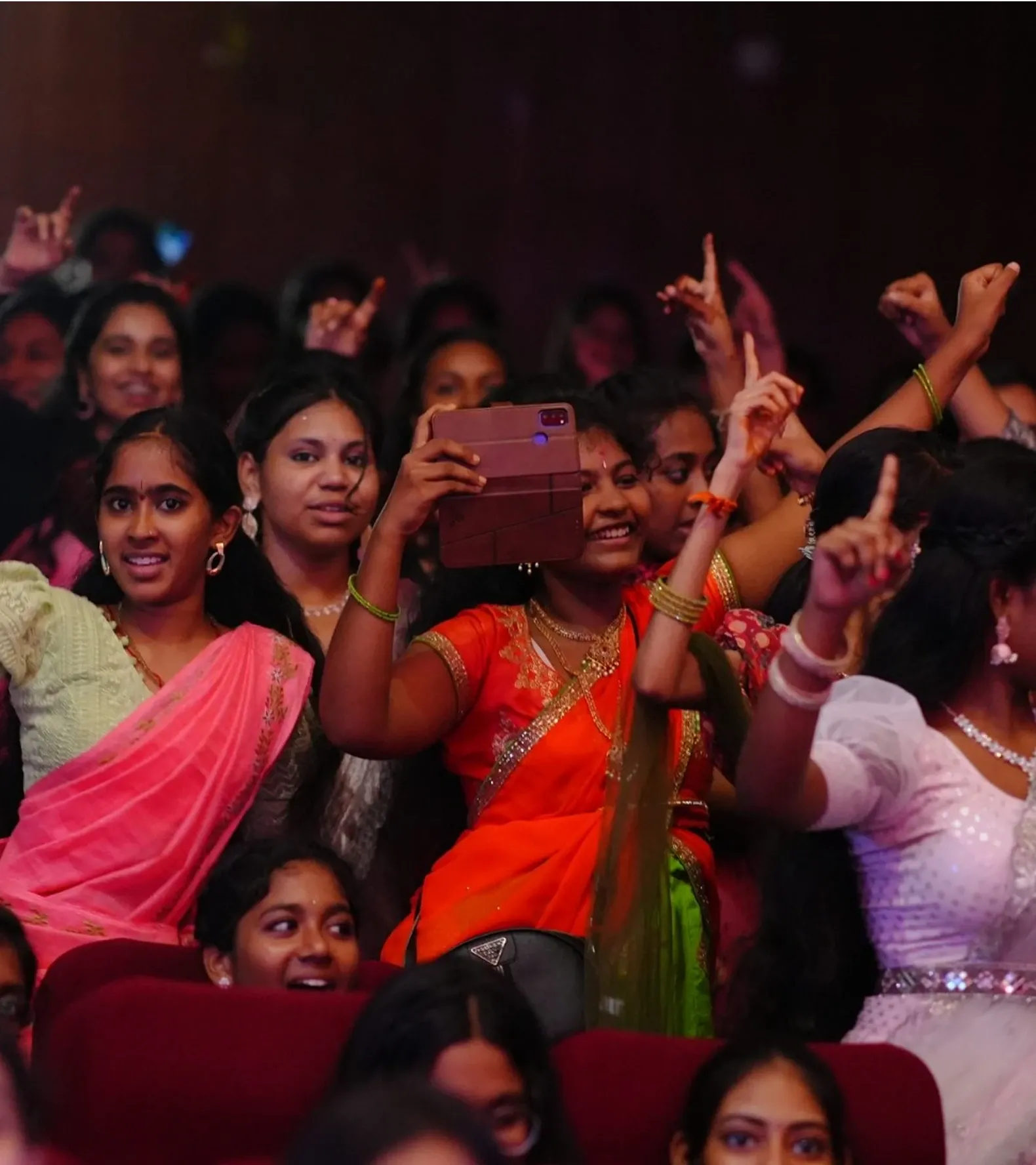 Students cheering and recording the Annual Day performances