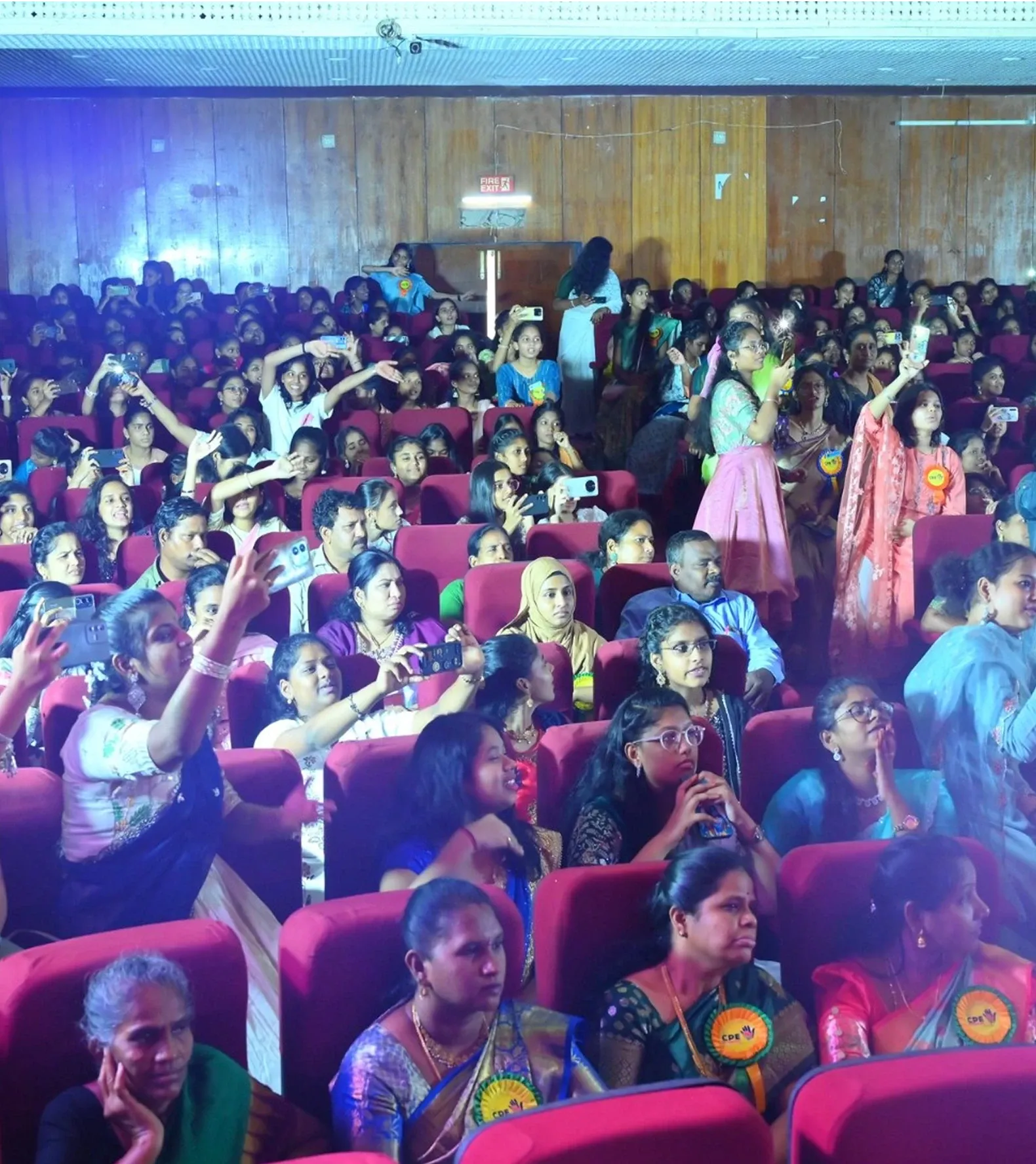 Parents, students, and faculty watching the celebrations in the auditorium