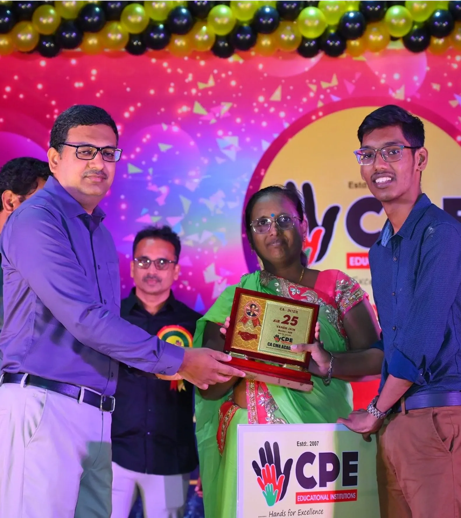 A CA Inter All India Rank 25 achiever being felicitated with a parent
