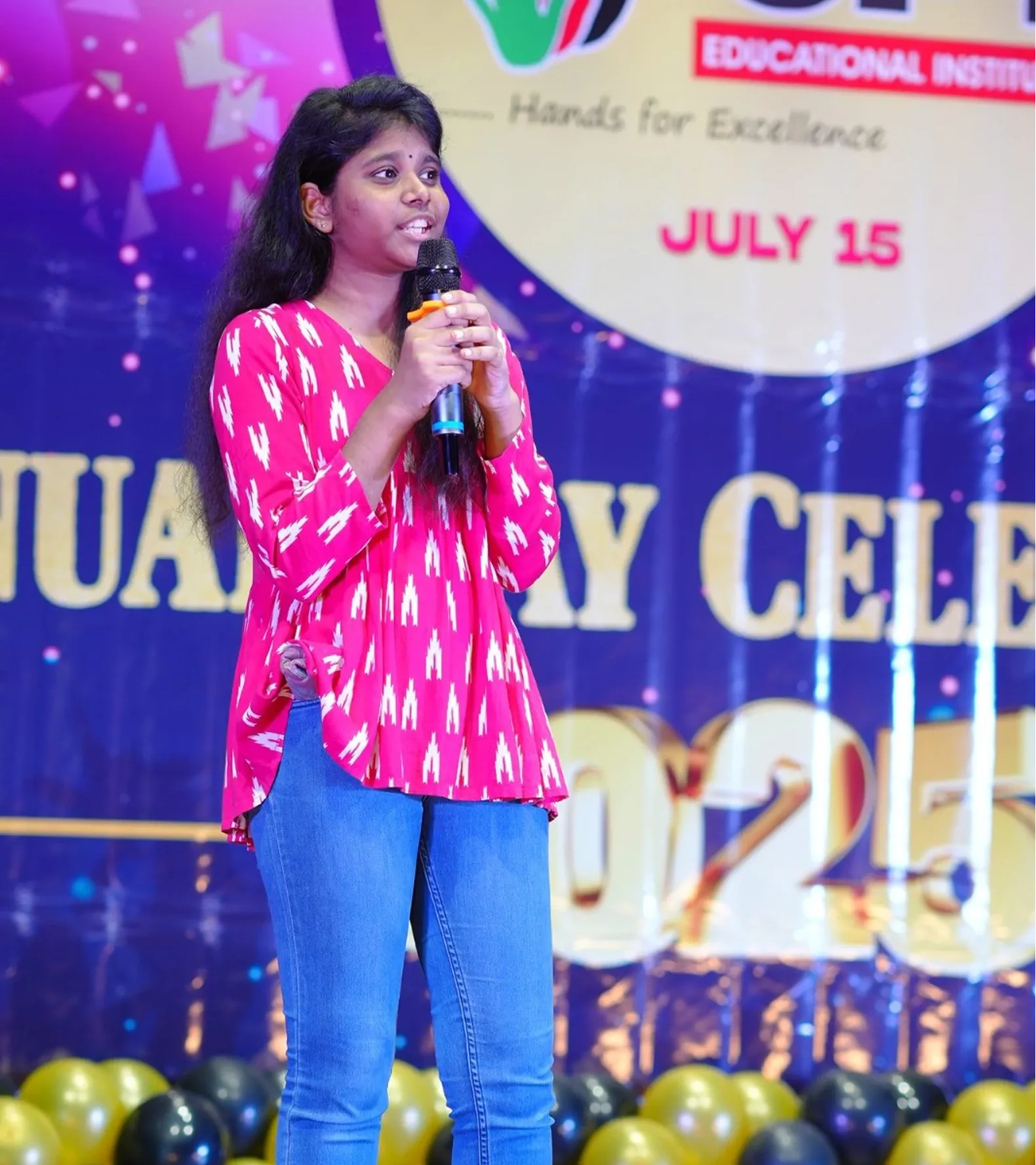 A student anchoring the Annual Day programme with a microphone