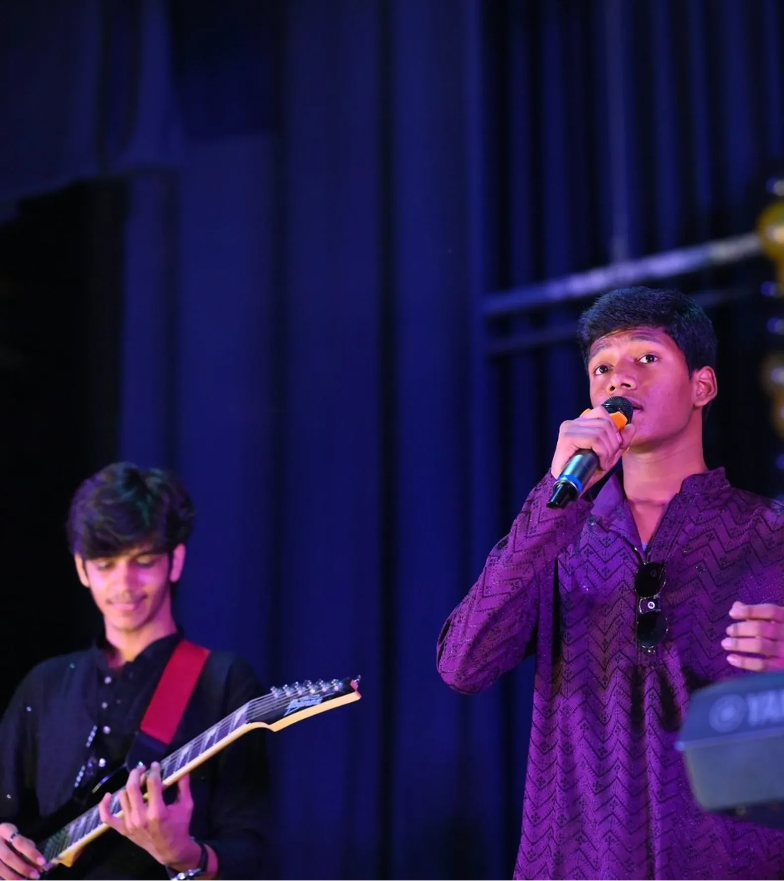 Students performing vocals and guitar as part of the Annual Day programme