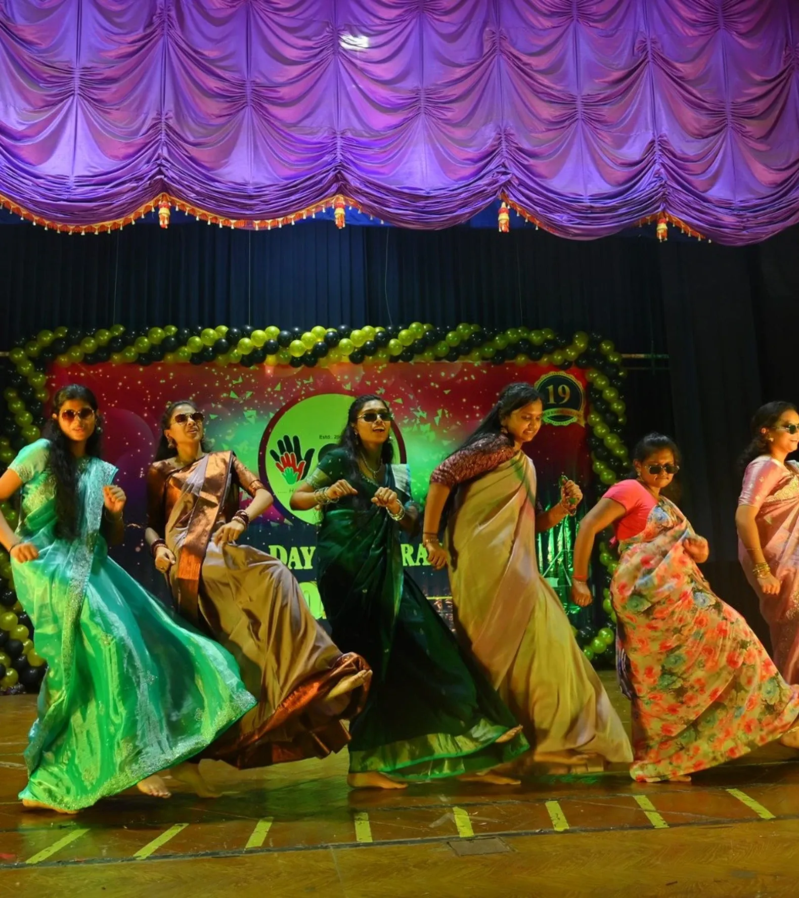 Students performing a group dance in traditional attire